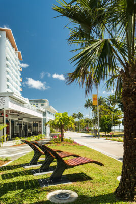 Fixed wooden lounge chairs along waterfront precinct