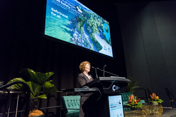 Female speaker at lectern speaking at conference