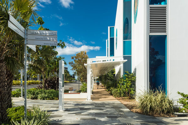 View along pedestrian walkway surrounded by tropical gardens