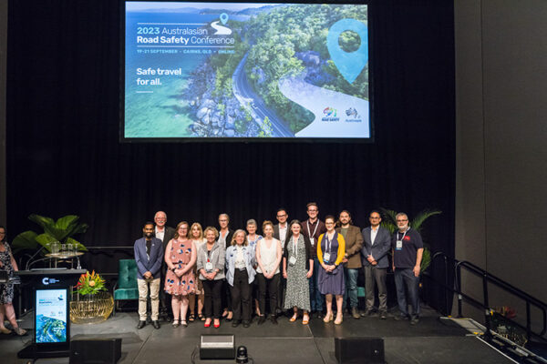 Group photo of board members on stage at conference