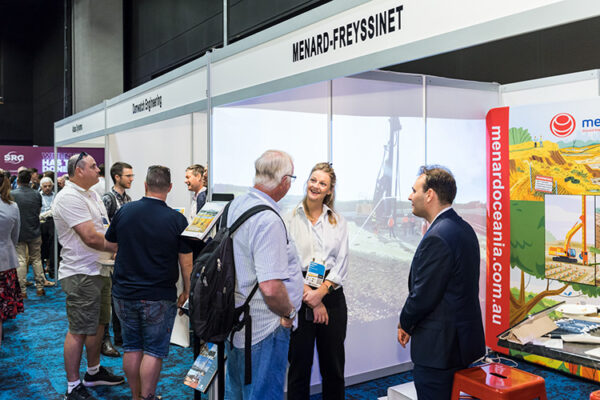 People talking on trade show floor at conference