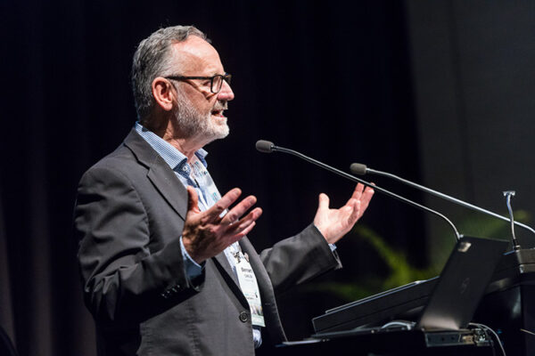 Male speaker at lectern speaking at conference