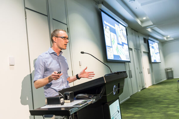 Male speaker at lectern speaking at conference