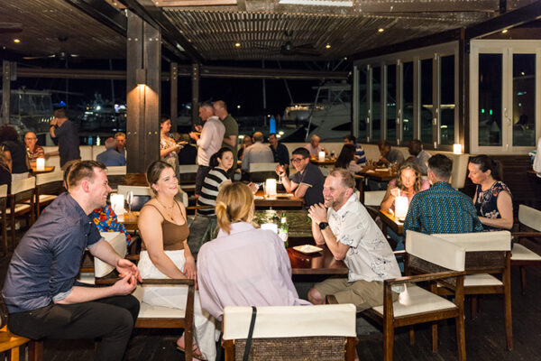 Delegates networking at conference social event at bar