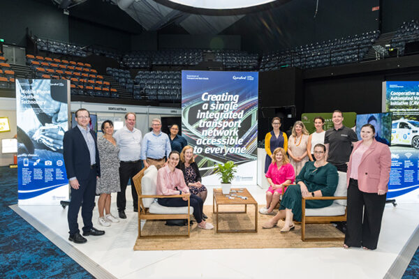 Group photo of exhibitor team at a conference trade show