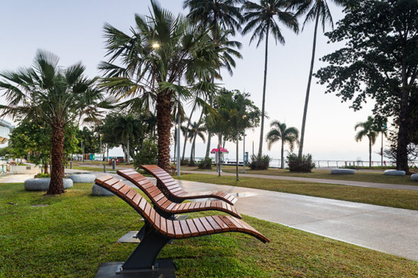 Contemporary wooden seating and palm fringed waterfront in Cairns