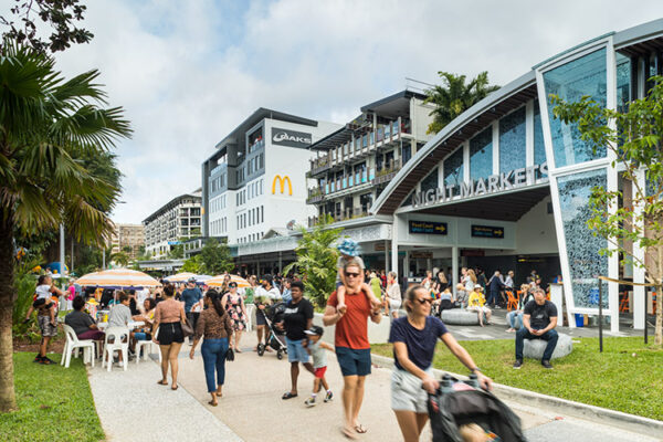 People walking along the Esplanade promenade with restaurant diners in background