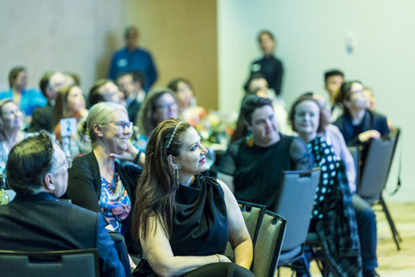 Delegates listening to a speaker at a conference awards finner