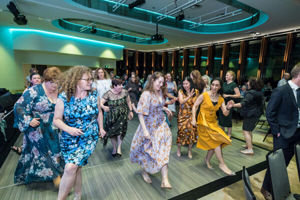 Female delegates dancing at a conference dinner event