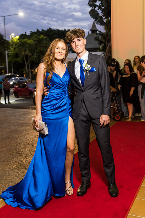 Young couple dressed up on red carpet for senior formal arrivals