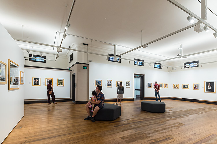 People viewing a photographic exhibition in one of the Mulgrave Gallery artspaces