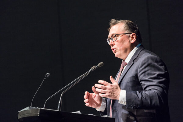 Male speaker at lectern speaking at conference