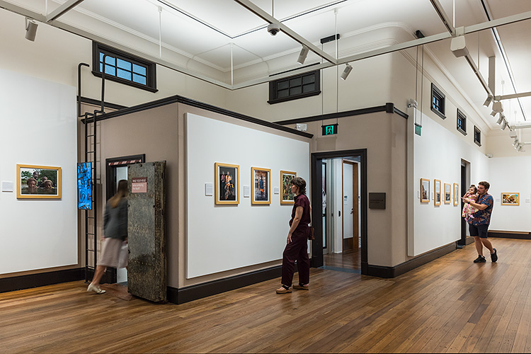 People viewing a photographic exhibition in one of the Mulgrave Gallery artspaces