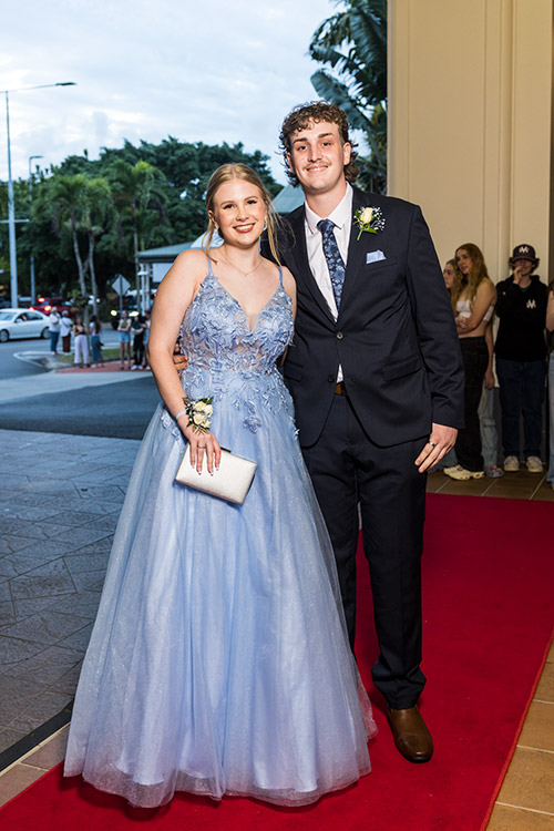 Young couple dressed up on red carpet for school formal arrivals