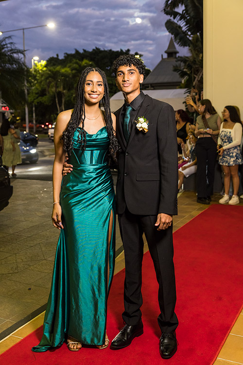 Young couple dressed up on red carpet for school formal arrivals