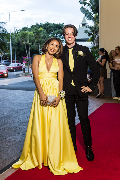 Young couple dressed up on red carpet for school formal arrivals