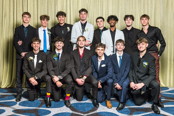 Group photo of male students at school formal photographed against a gold backdrop