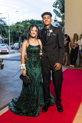 Young couple dressed up on red carpet for school formal arrivals