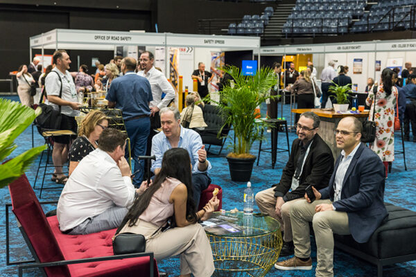 Delegates talking and networking at a conference trade show