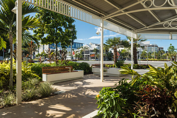Seating and pedestrian walkway surrounded by tropical gardens